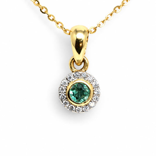 Natural Colombian emerald and diamond halo pendant in 18K white and yellow gold