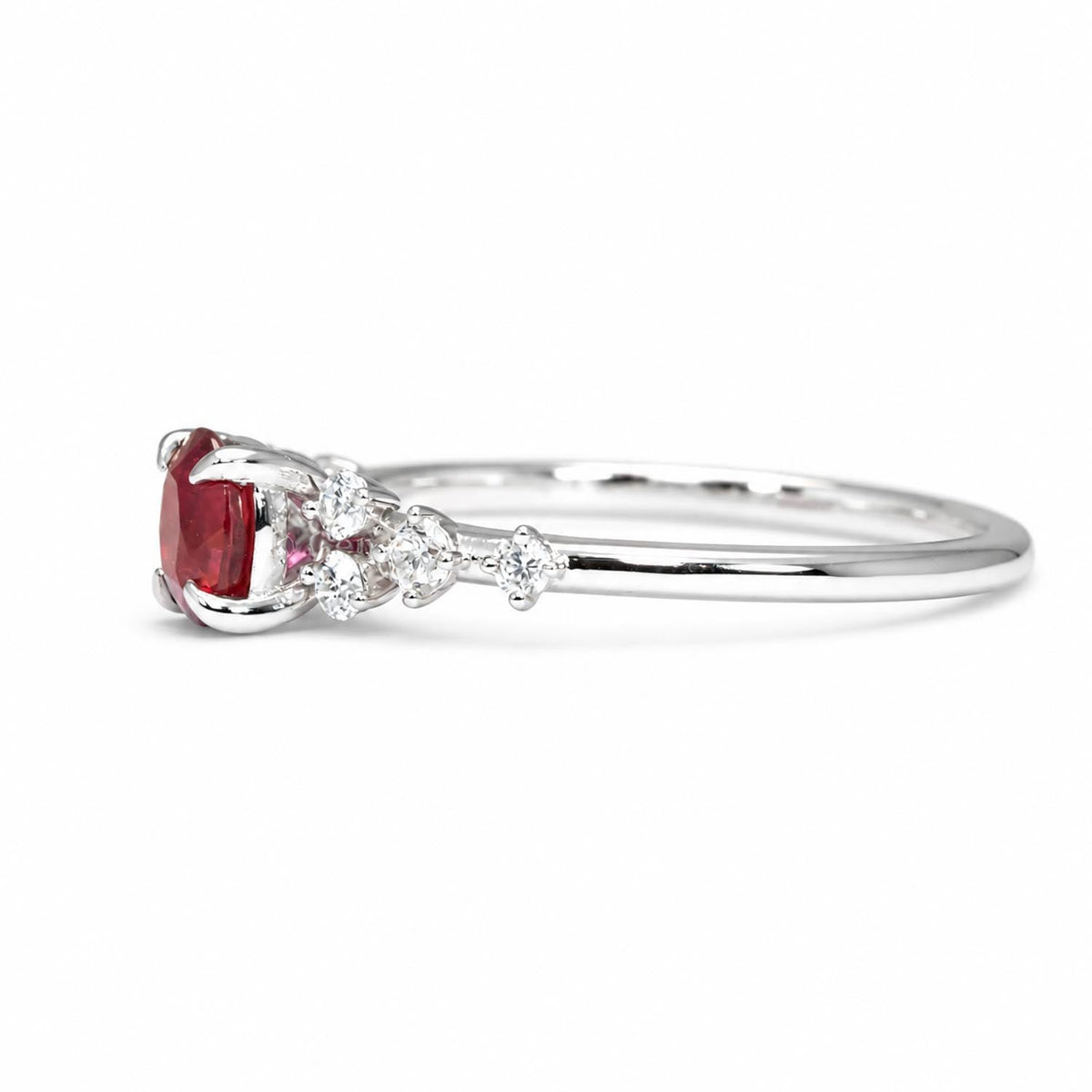 Oval ruby and diamond ring in platinum 950 shown at an angle