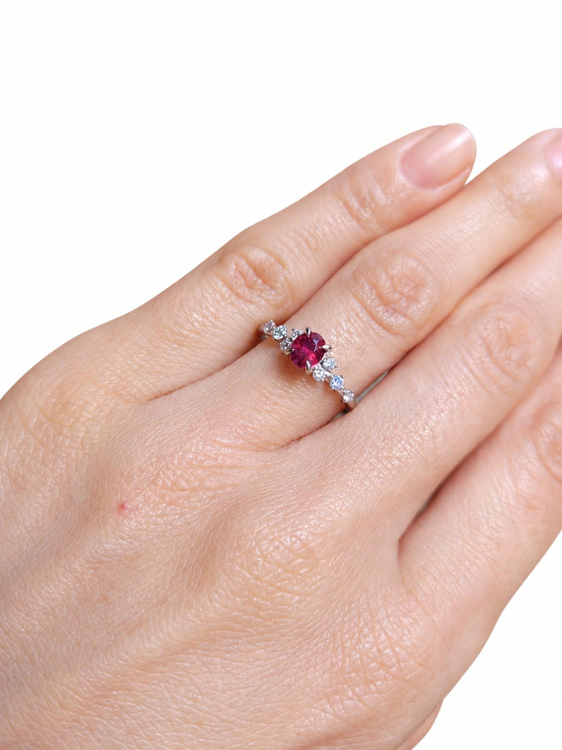 Side profile of the 0.55ct oval ruby and diamond platinum ring