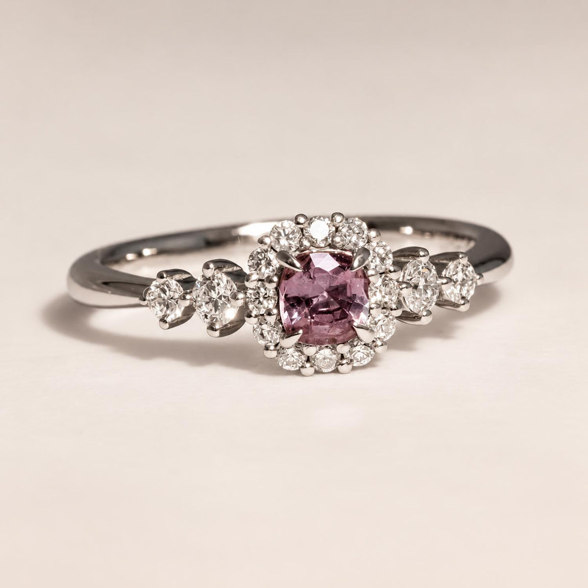 Cushion cut alexandrite halo ring in 18K yellow gold shown at an angle