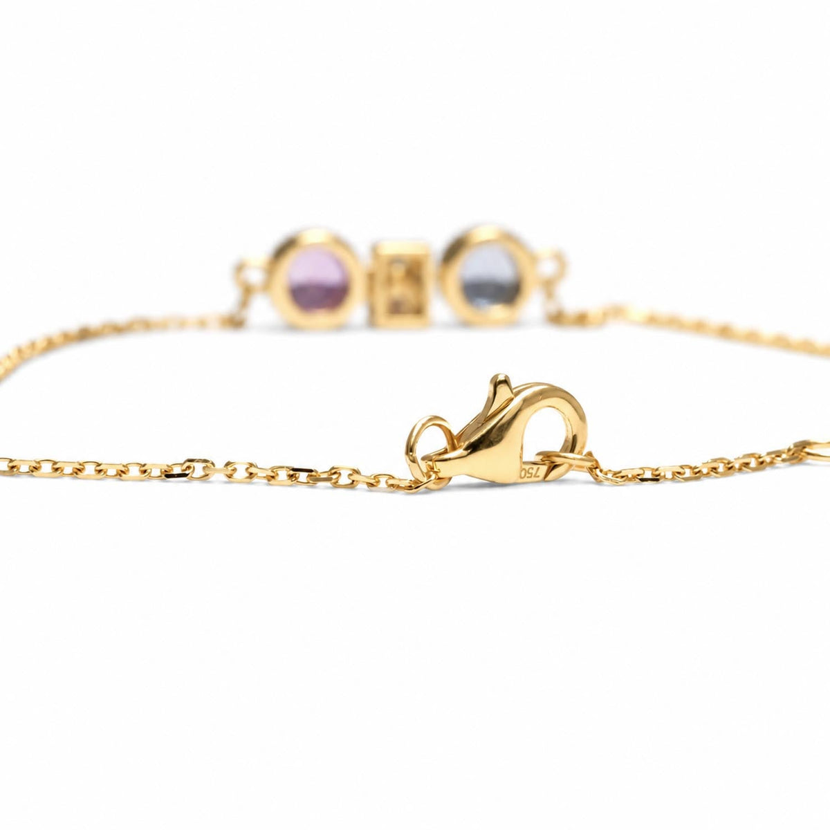 Close detail of the unheated pink and blue sapphires set in 18K yellow gold
