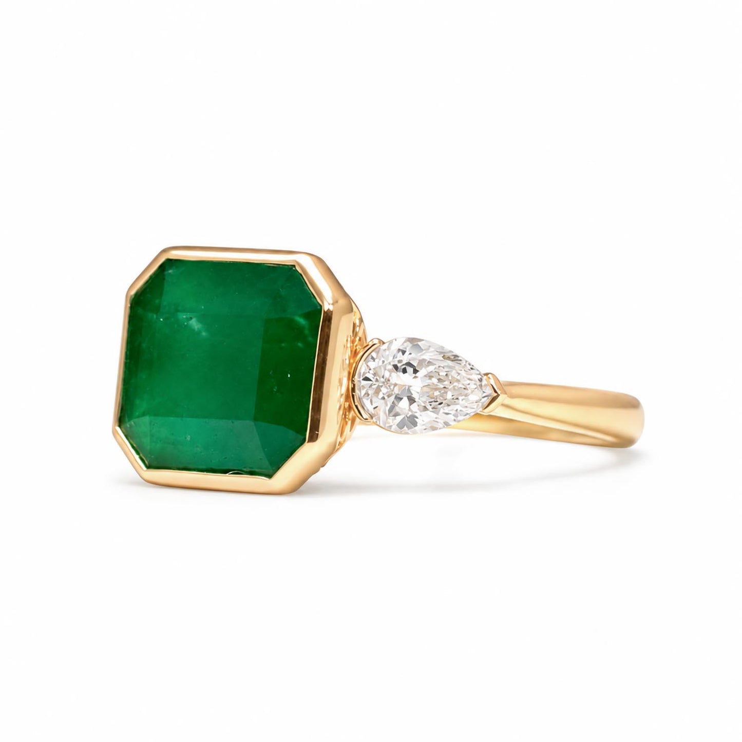 side view of Colombian Emerald and Diamond Ring in 18K Yellow Gold – East West Emerald Cut in white background