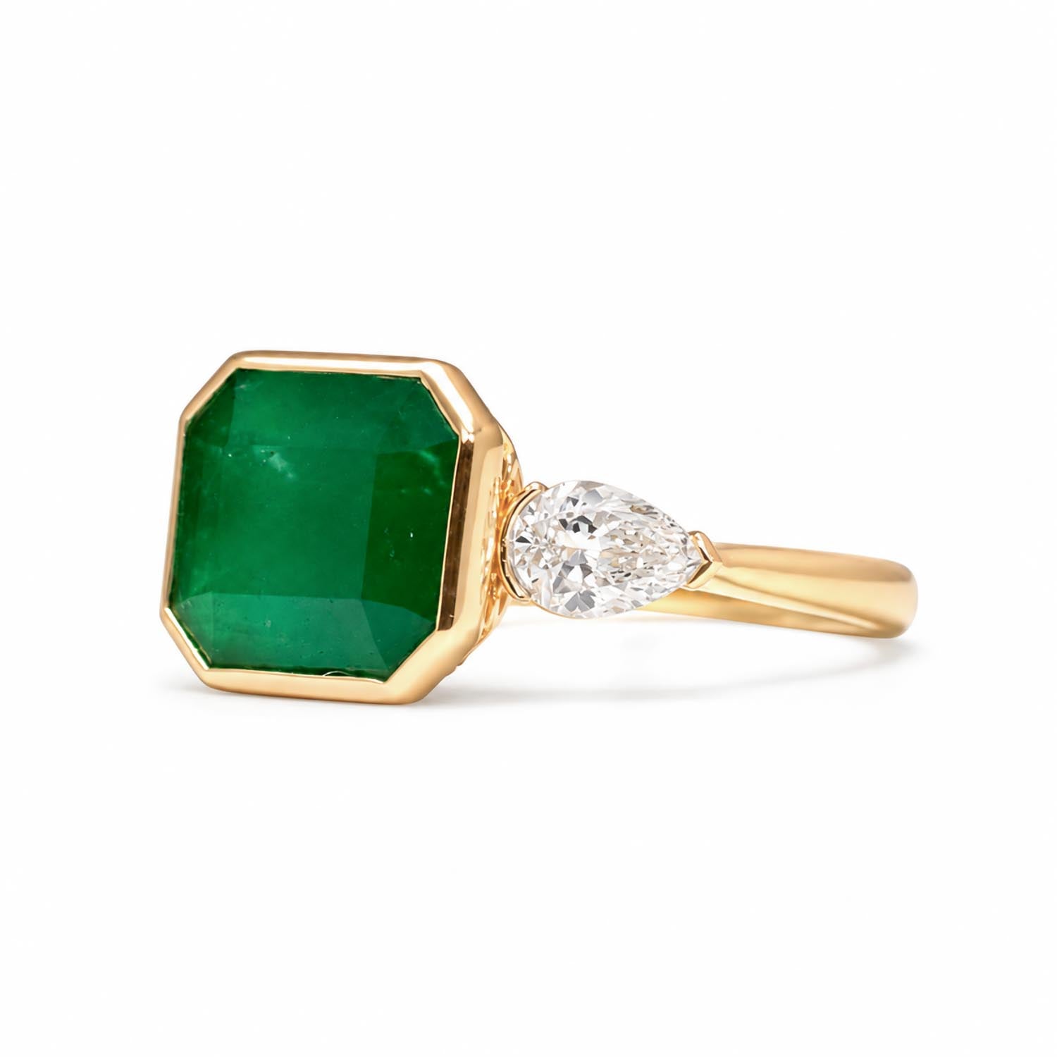 side view of Colombian Emerald and Diamond Ring in 18K Yellow Gold – East West Emerald Cut in white background