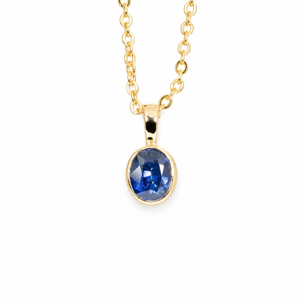 1.08ct oval royal blue sapphire pendant in 18K yellow gold, angled view