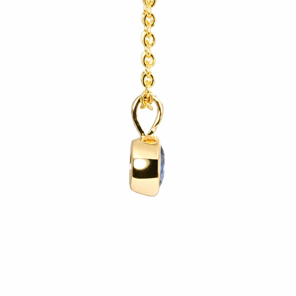 Close detail of the oval cut royal blue sapphire in 18K yellow gold