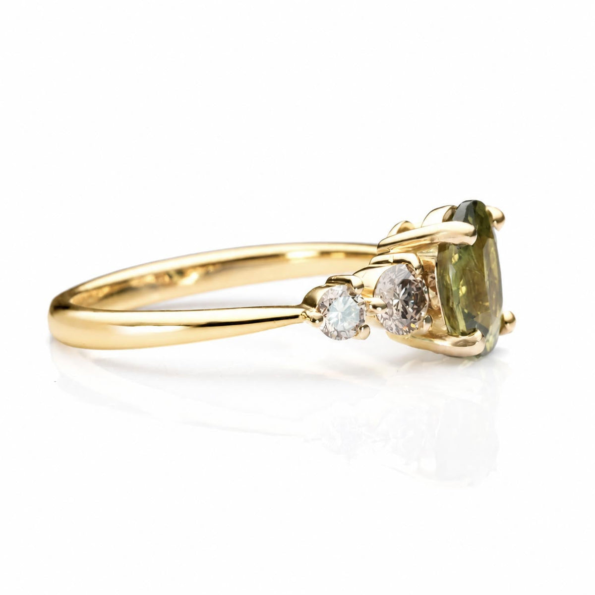 Oval green sapphire with Argyle champagne diamonds in 18K yellow gold, angled view
