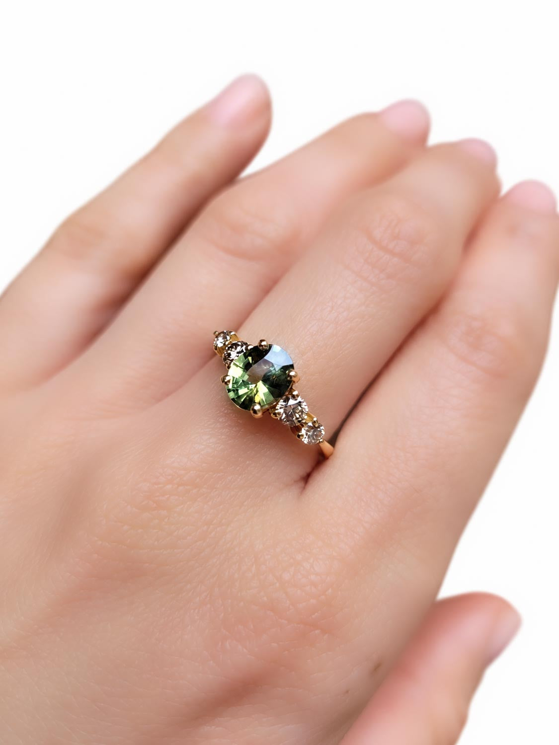 Close detail of the 1.63ct oval green sapphire centre stone