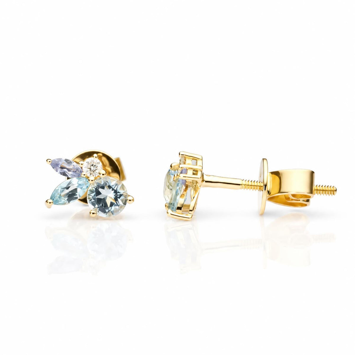Aquamarine, topaz and tanzanite diamond earrings in gold shown at an angle