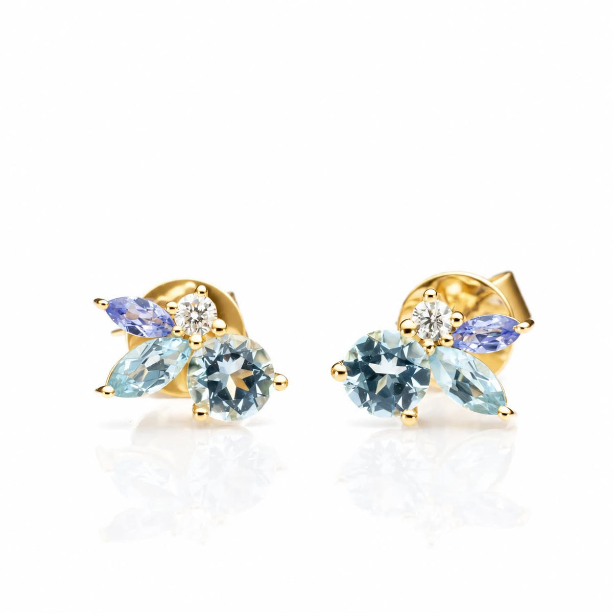 Close detail of the aquamarine, topaz and tanzanite drops in 18K yellow gold