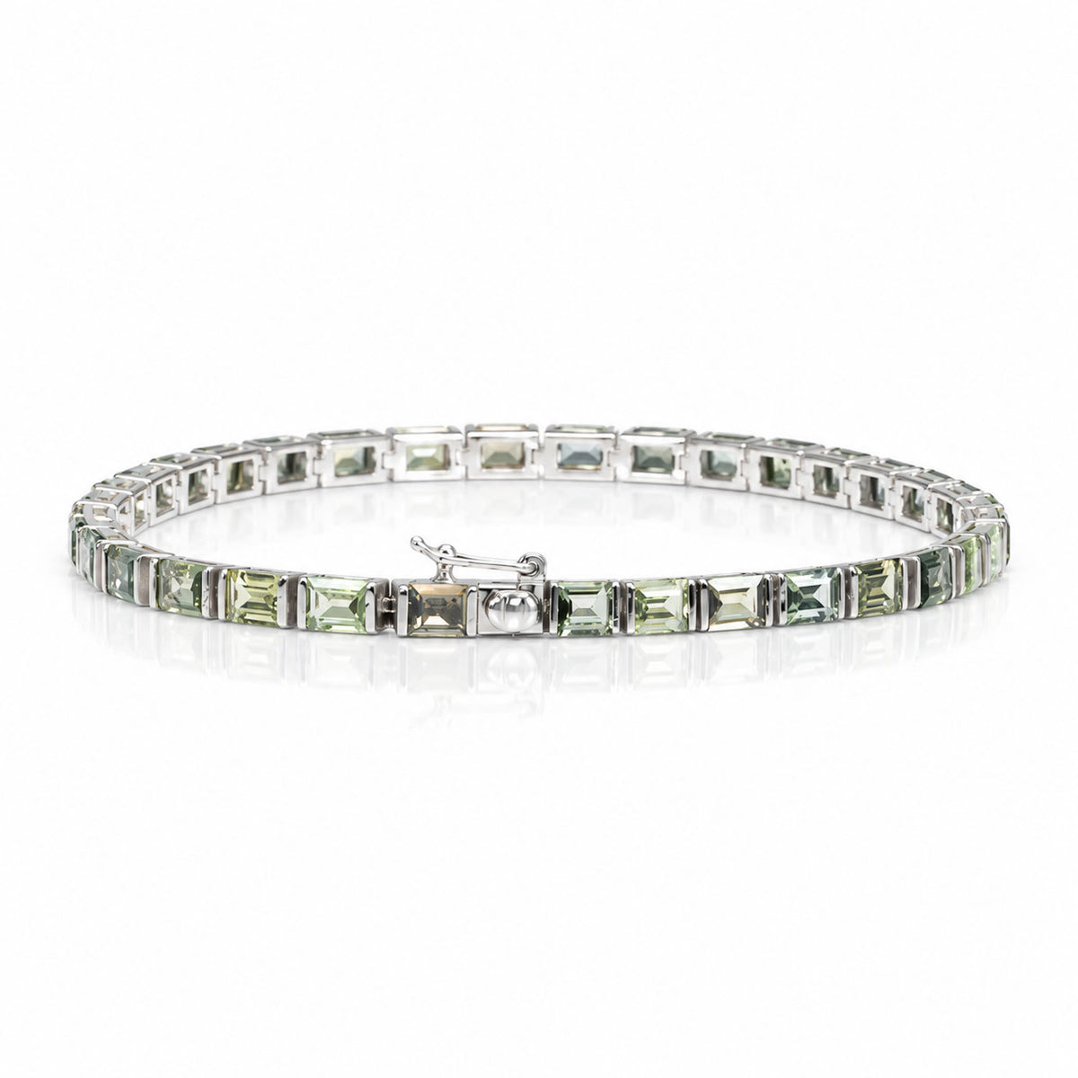 view of the closing mechanism of a tennis bracelet that features princess cut teal sapphires