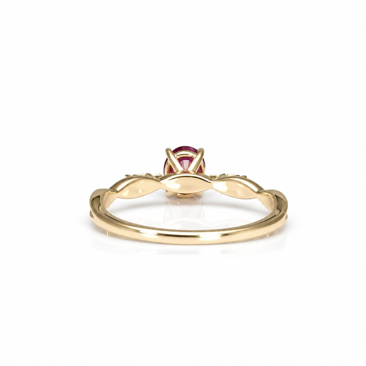 back view of a yellow gold ring with a twisted band and ruby in the center, shown on a clean white background.