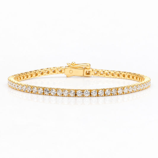 a yellow gold diamond tennis bracelet shown on a white background with a soft reflection 