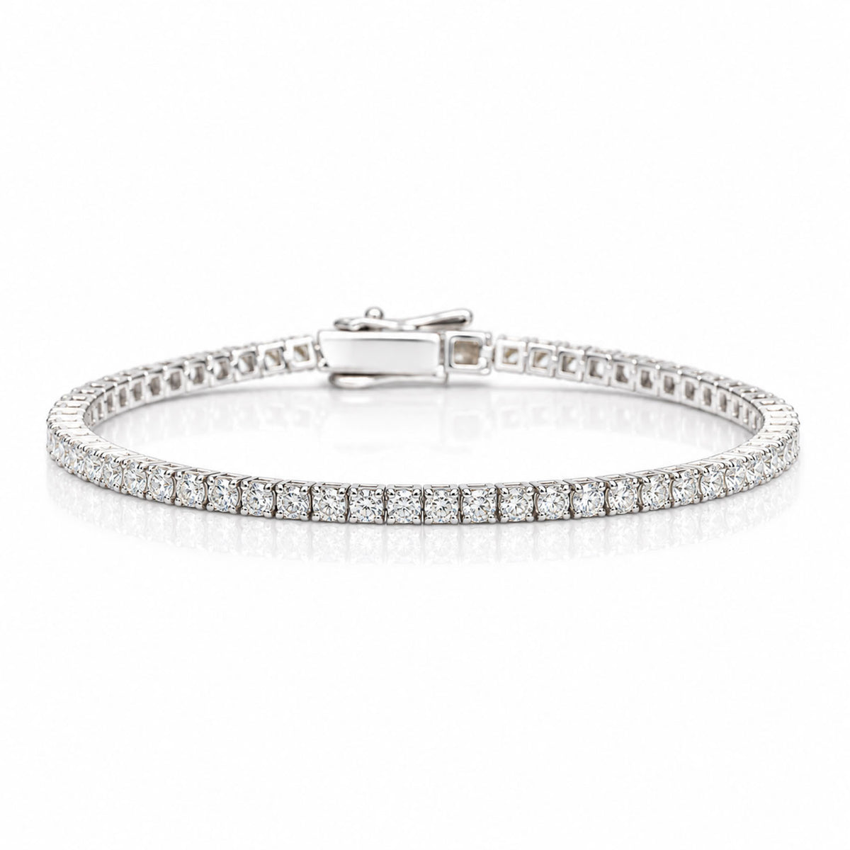 A platinum tennis bracelet with round brilliant cut diamonds shown on a white background with a soft reflection