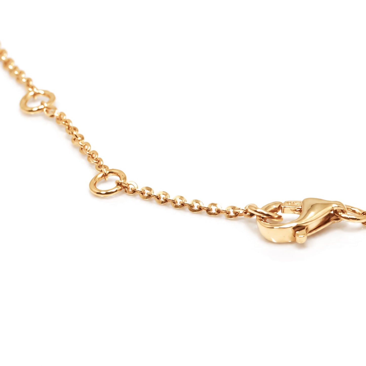 A close-up of the clousure points of a  gold bracelet featuring lobster clasp, shown on a plain white background.