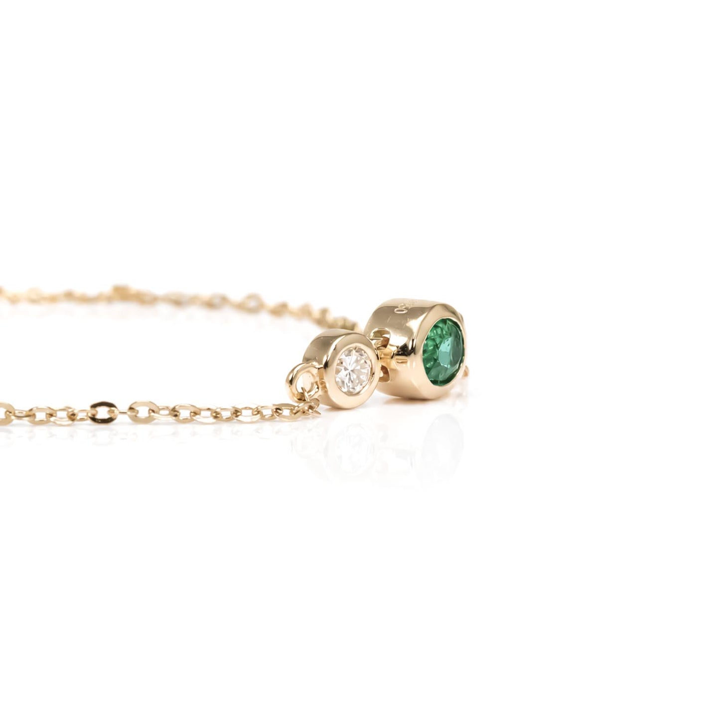 side view of a Natural Colombian Emerald & Diamond Bracelet in 18K Yellow Gold in a white background