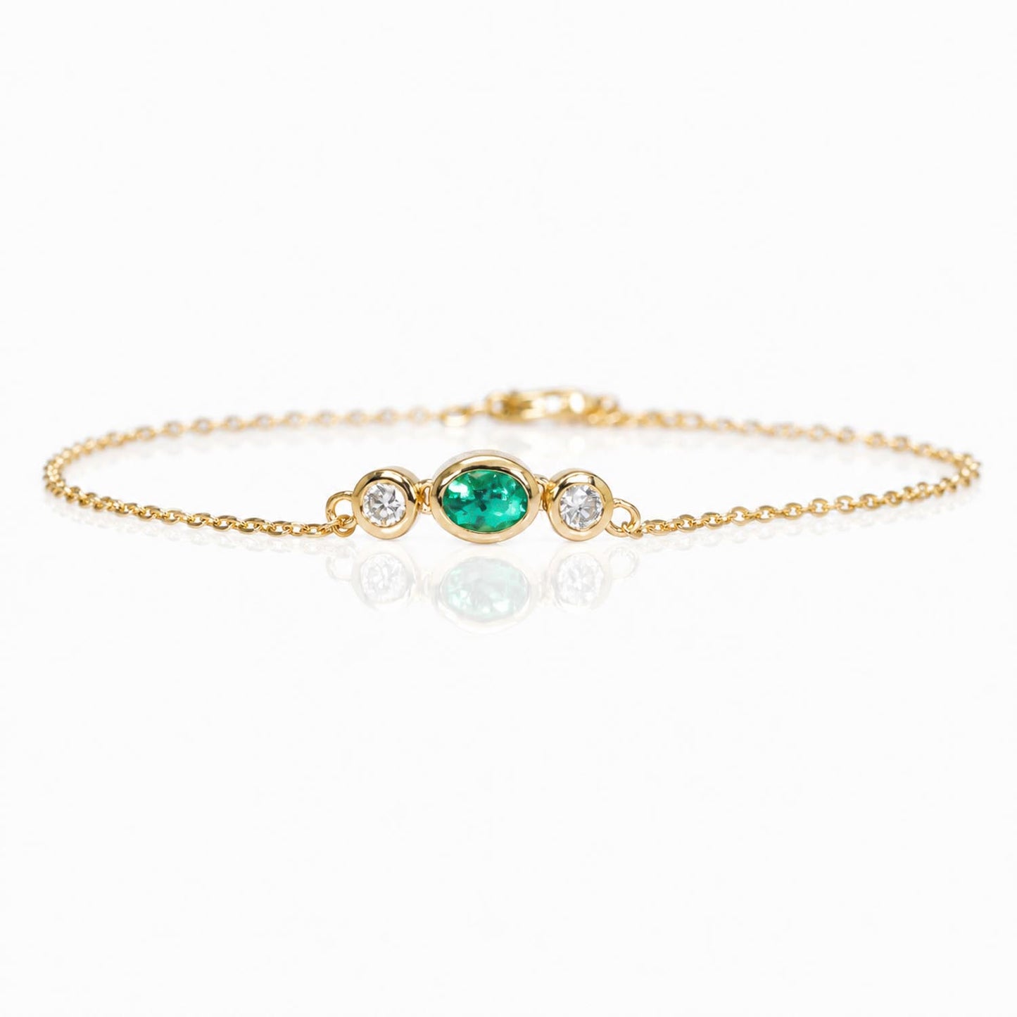 front view of a Natural Colombian Emerald & Diamond Bracelet in 18K Yellow Gold in a white background