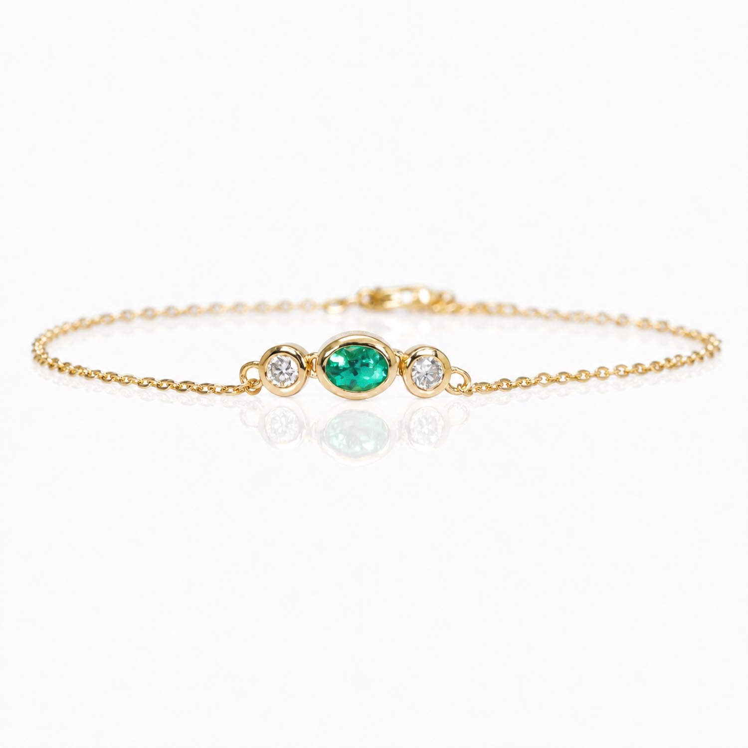 front view of a Natural Colombian Emerald & Diamond Bracelet in 18K Yellow Gold in a white background
