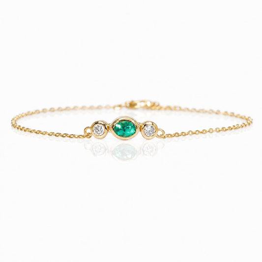 front view of a Natural Colombian Emerald & Diamond Bracelet in 18K Yellow Gold in a white background