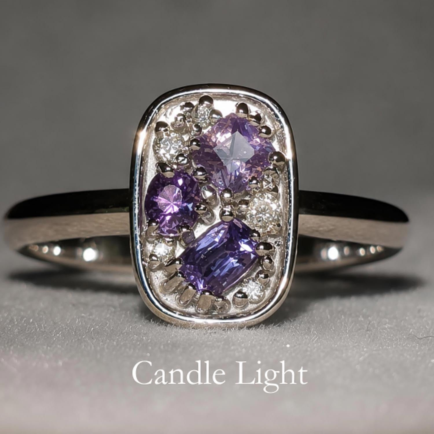 front view under incandescent light of Natural Alexandrite & Diamond Composition Ring in Platinum on gray background