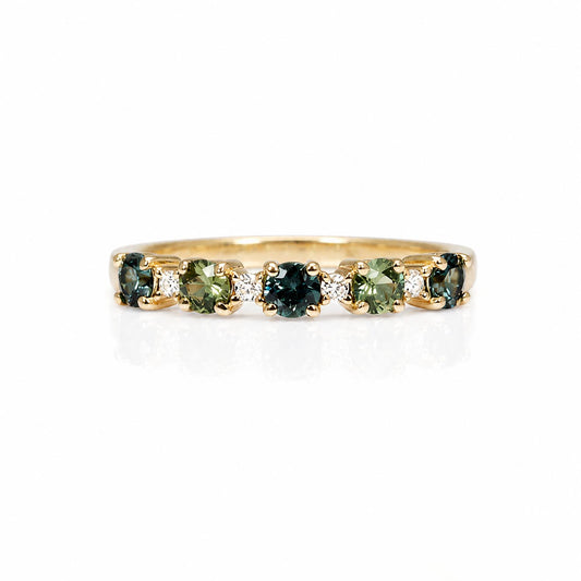 A yellow gold half eternity ring featuring five round-cut Australian sapphires and small accent diamonds, set against a plain white background.