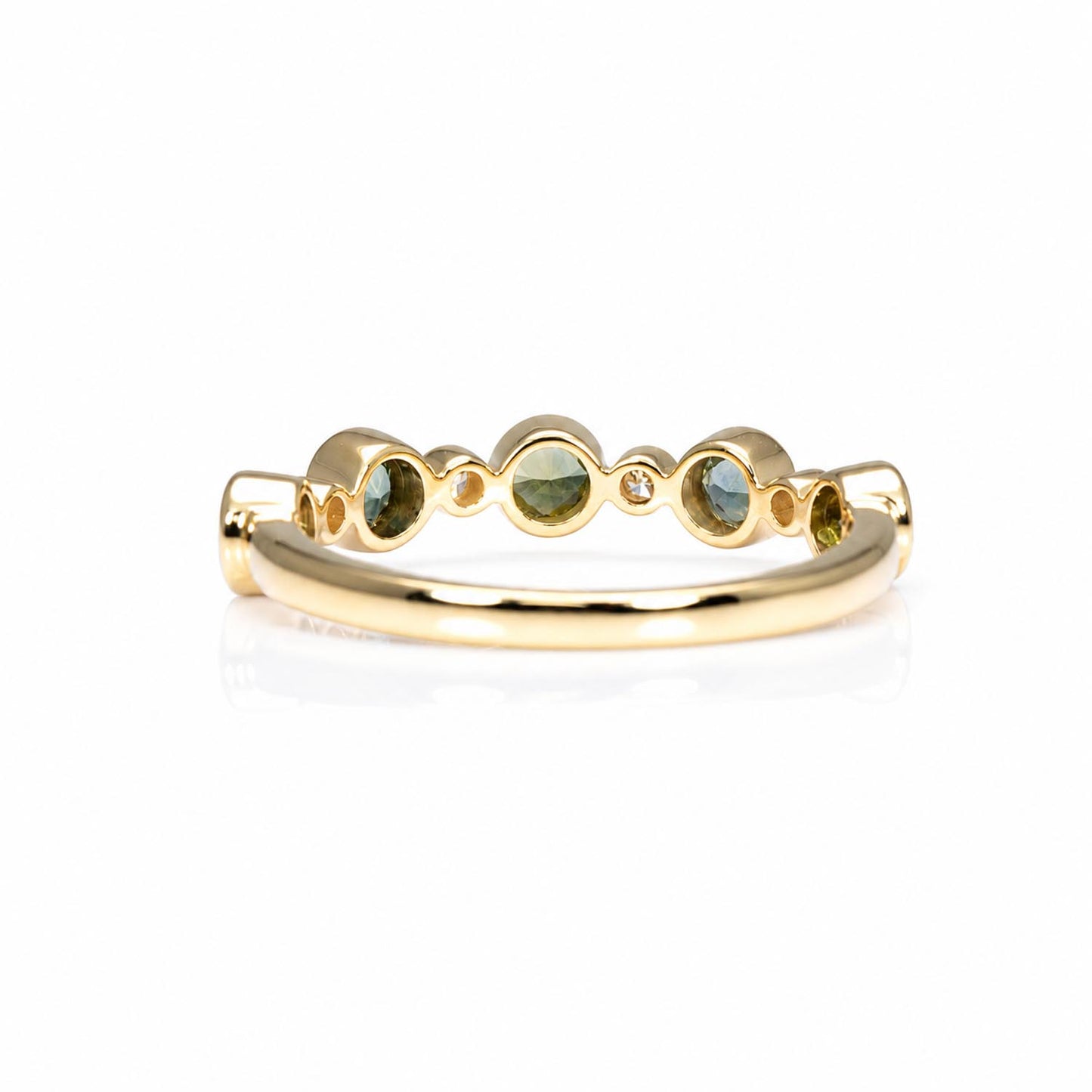 back view of a half eternity band featuring five round Australian teal sapphires and five small diamonds accent stones, set against a clean white background with a soft reflection.