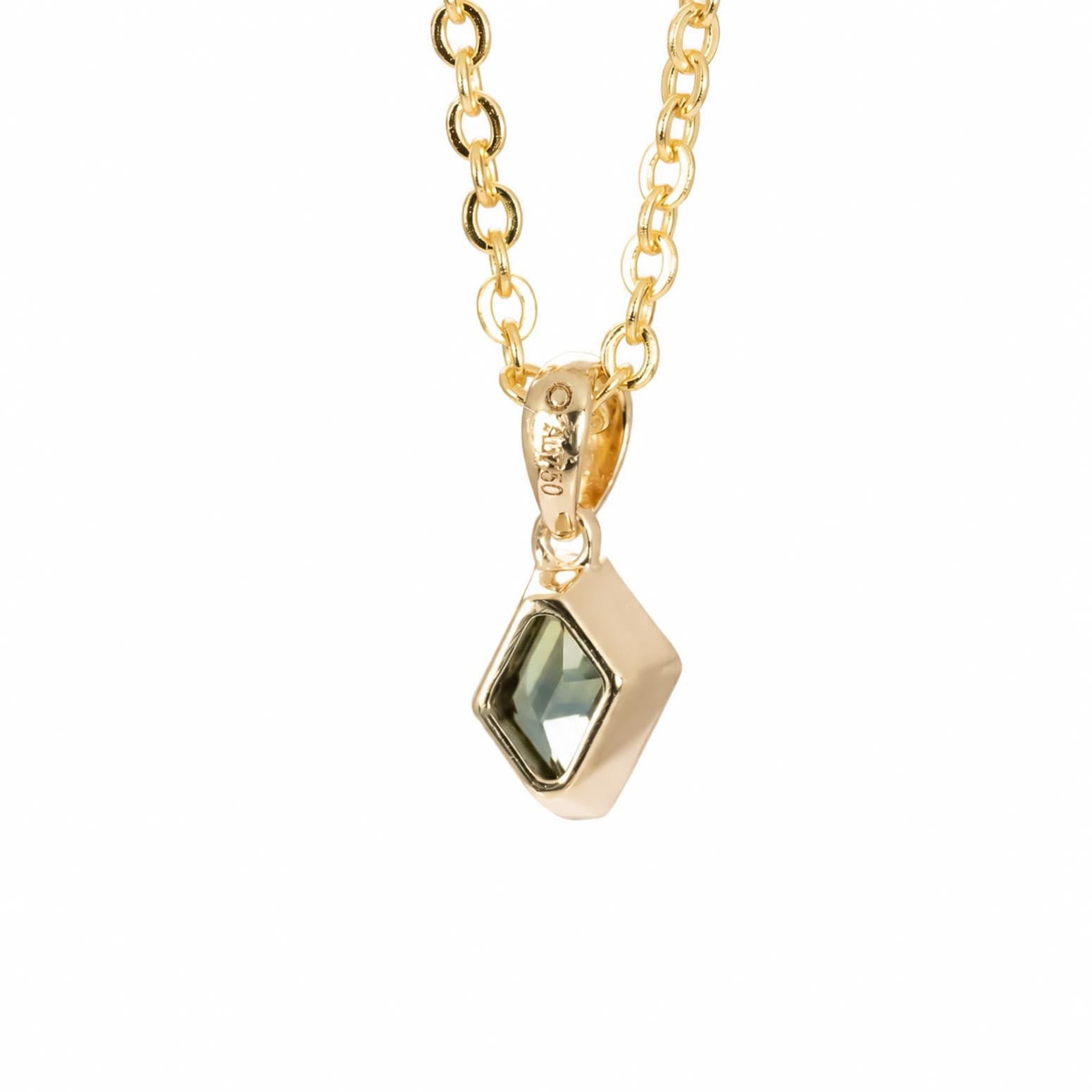 back view of a gold chain necklace with a geometric pendant featuring a teal green sapphire, shown against a plain white background.