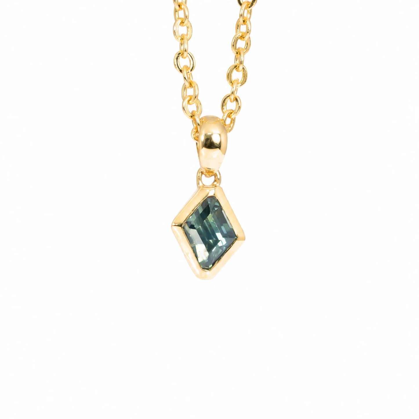 A gold chain necklace with a small diamond-shaped bezel setting holding a teal sapphire, shown against a plain white background.