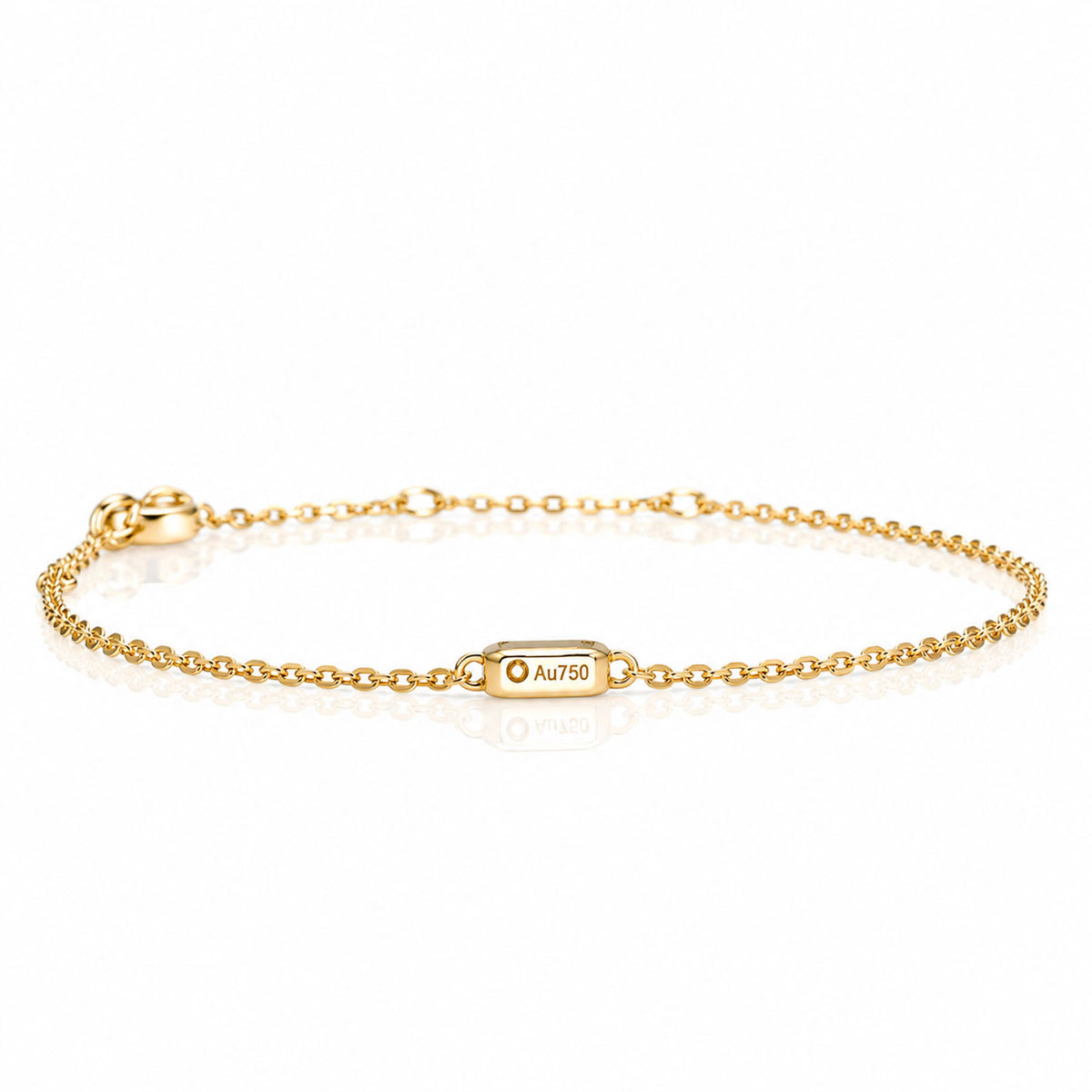 A delicate gold chain bracelet with a central setting engraved with 'Au750', displayed on a clean white background with a soft reflection.