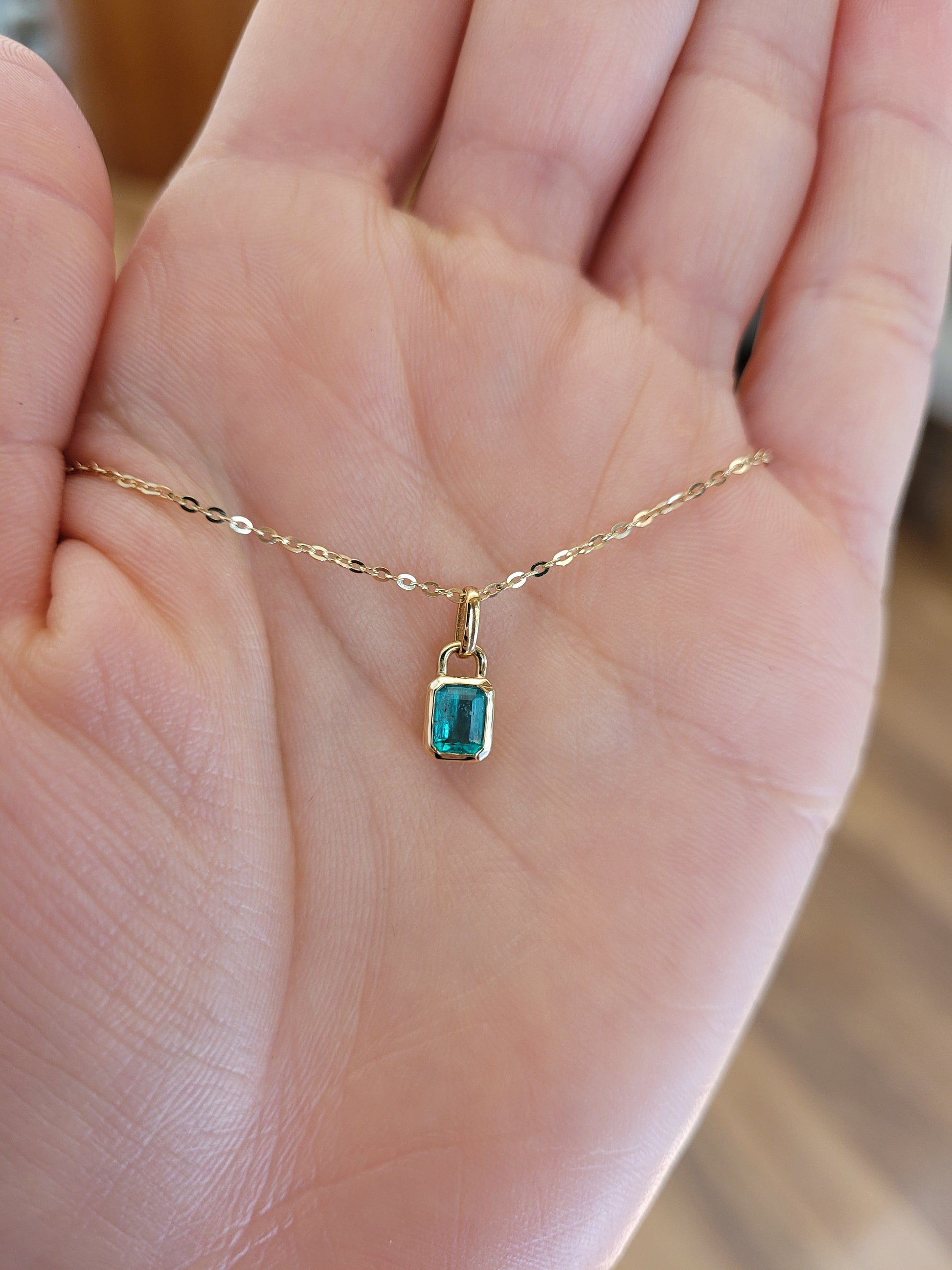 0.41ct Colombian Emerald Pendant contrasted on skin