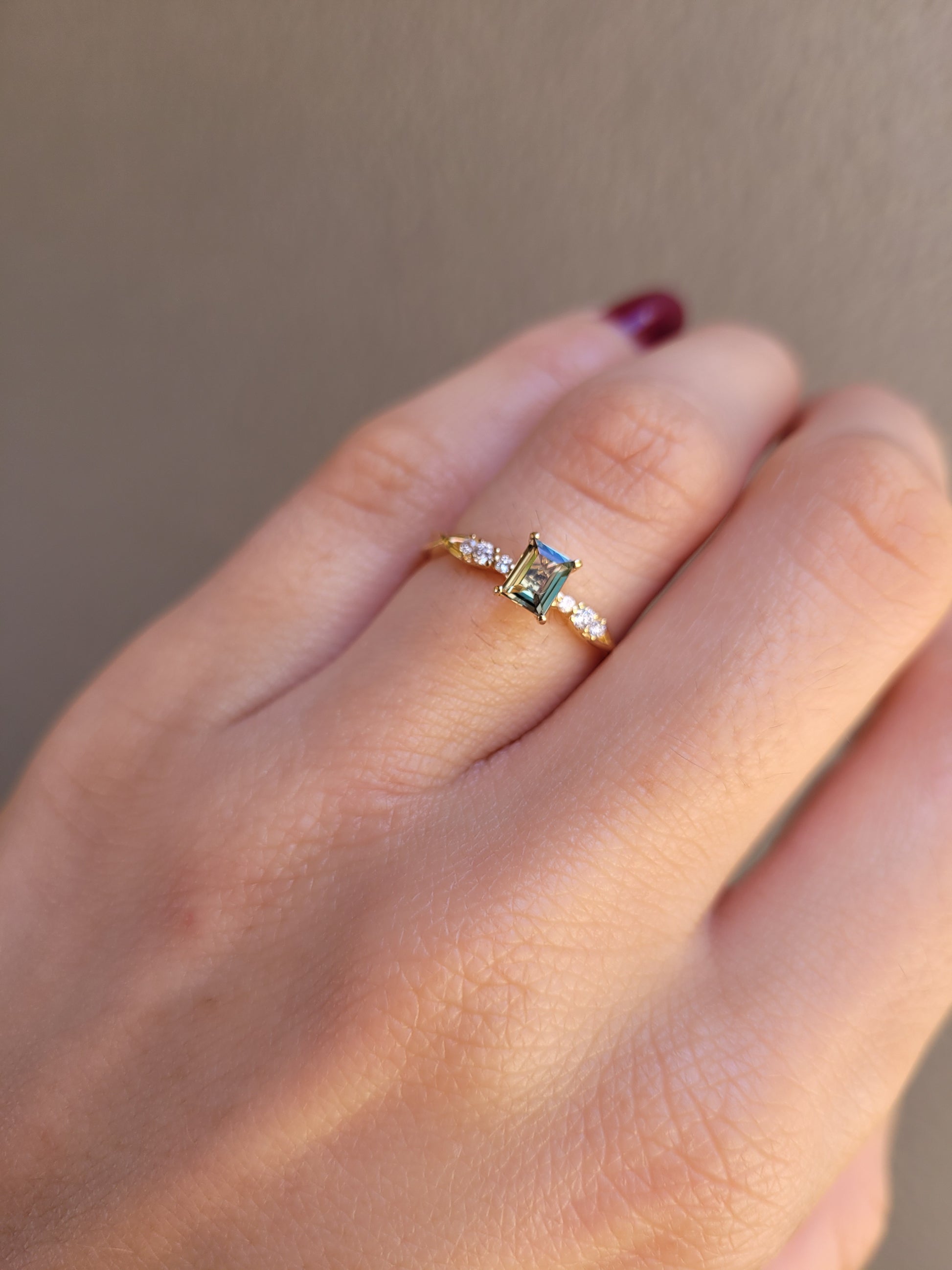 view of Natural Alexandrite and Diamond Ring 0.38ct Princess Cut in 18K Yellow Gold worn in a hand in neutral background