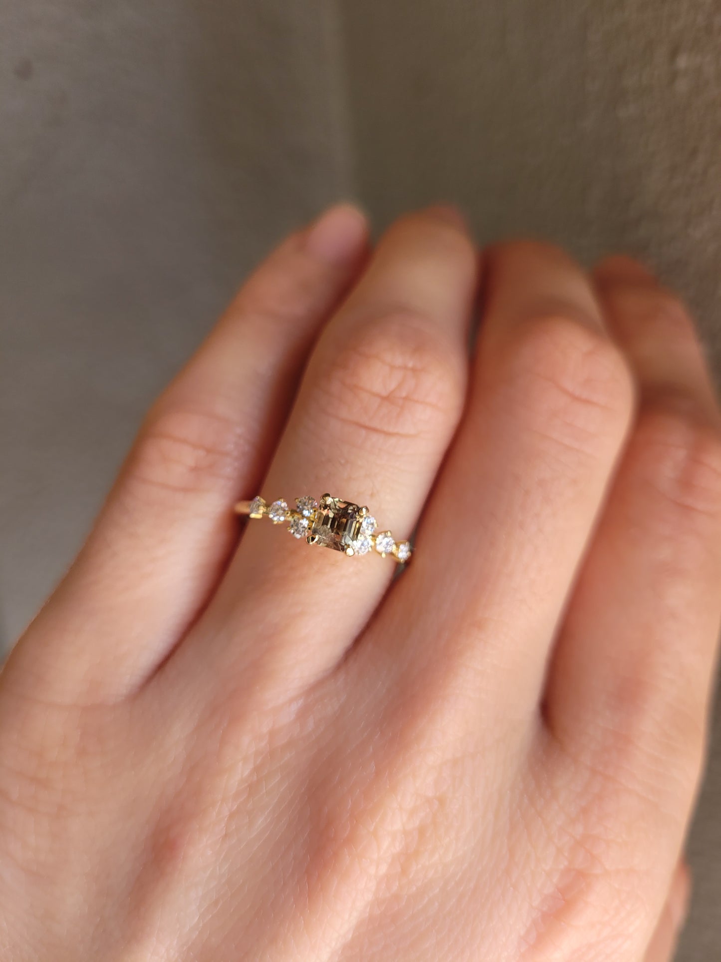photo on hand of of Natural Octagon Cut Alexandrite Ring 0.53ct with Diamond Accents in neutral background