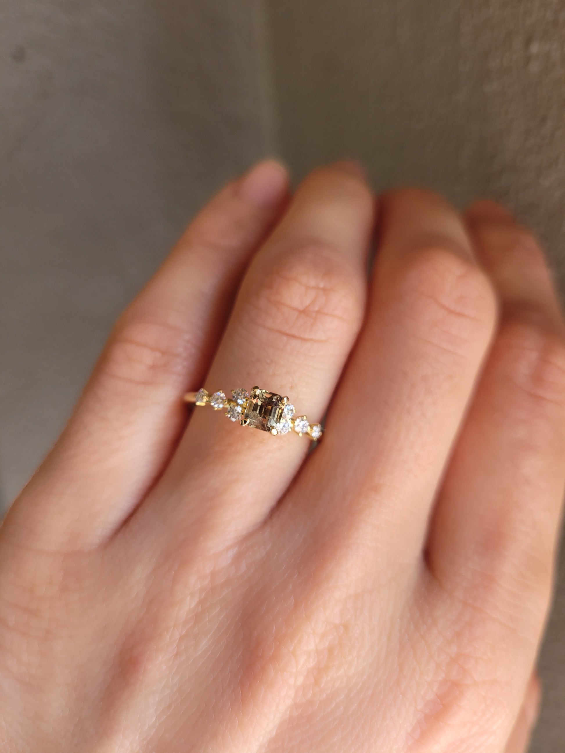 photo on hand of of Natural Octagon Cut Alexandrite Ring 0.53ct with Diamond Accents in neutral background