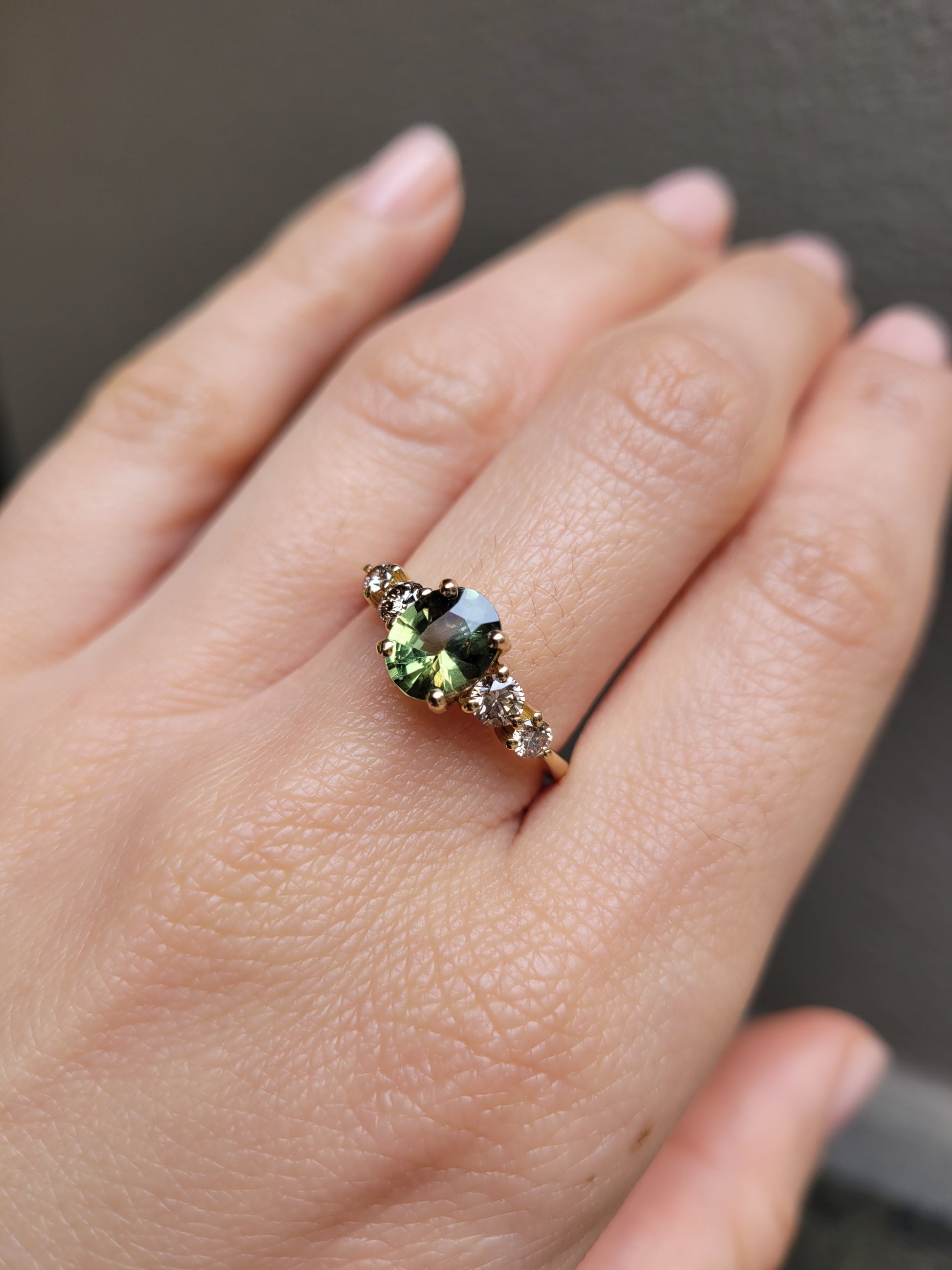 view on hand of Green Sapphire & Argyle Champagne Diamond Ring