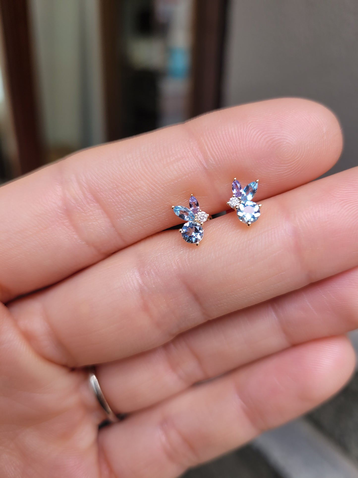 view against skin of Aquamarine, Topaz & Tanzanite Diamond Earrings