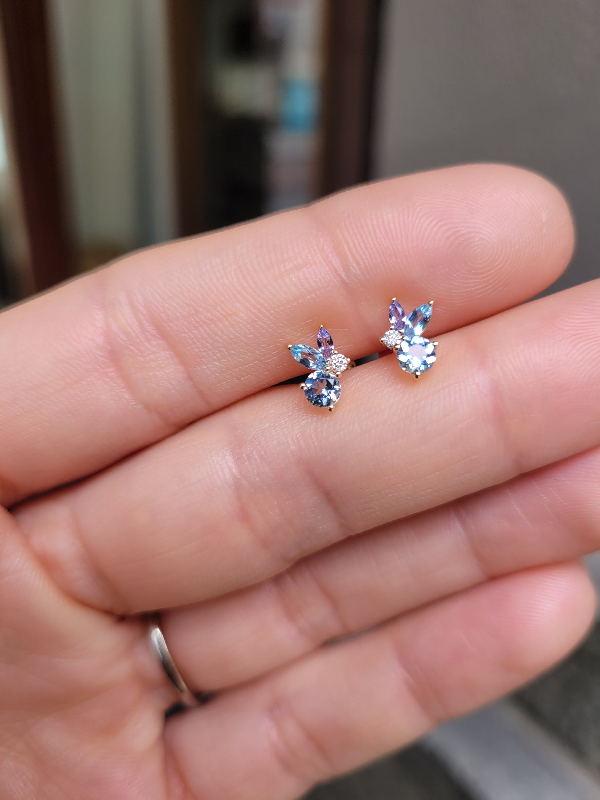 view against skin of Aquamarine, Topaz & Tanzanite Diamond Earrings