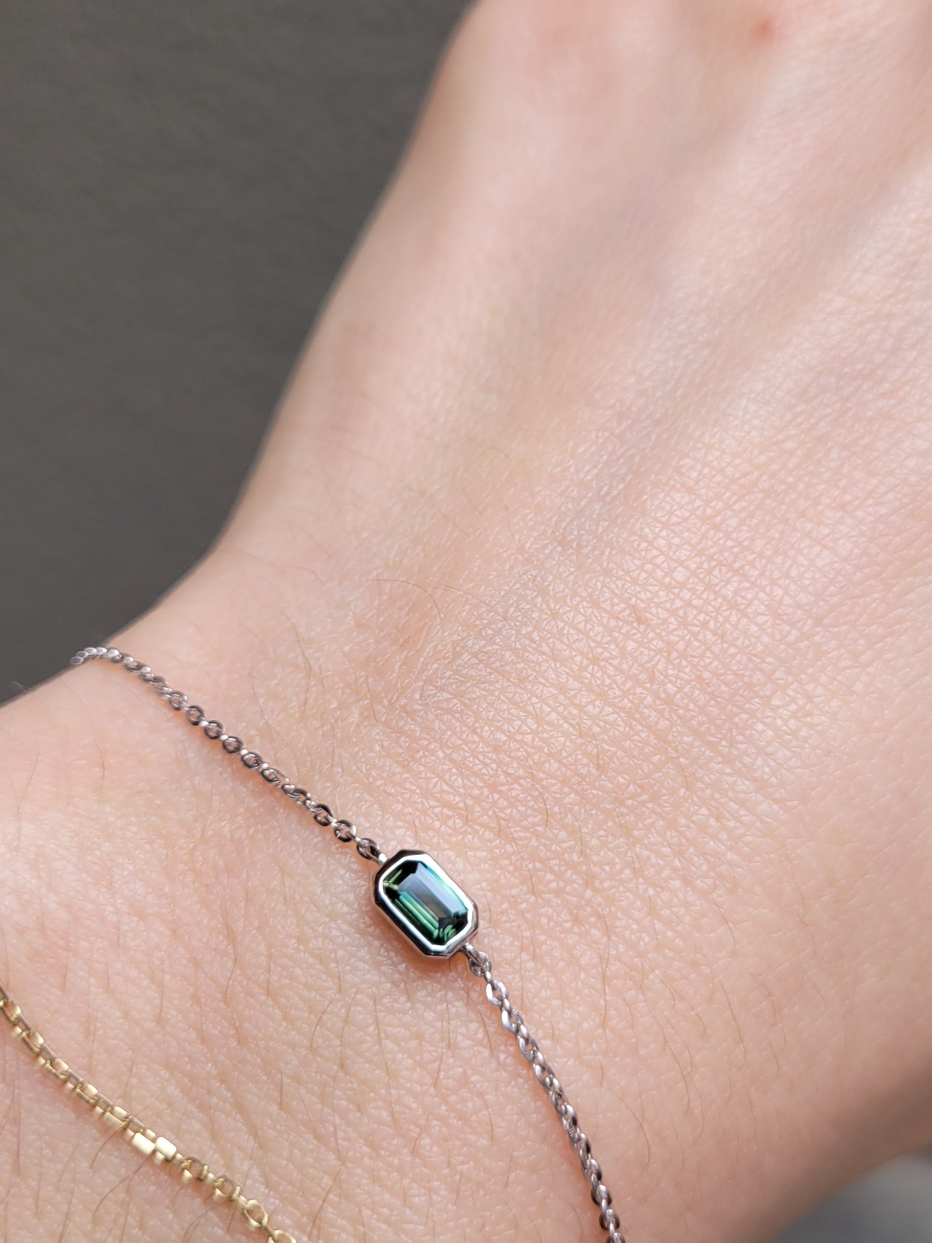 view on wrist of Australian Teal Sapphire Bracelet in Platinum 