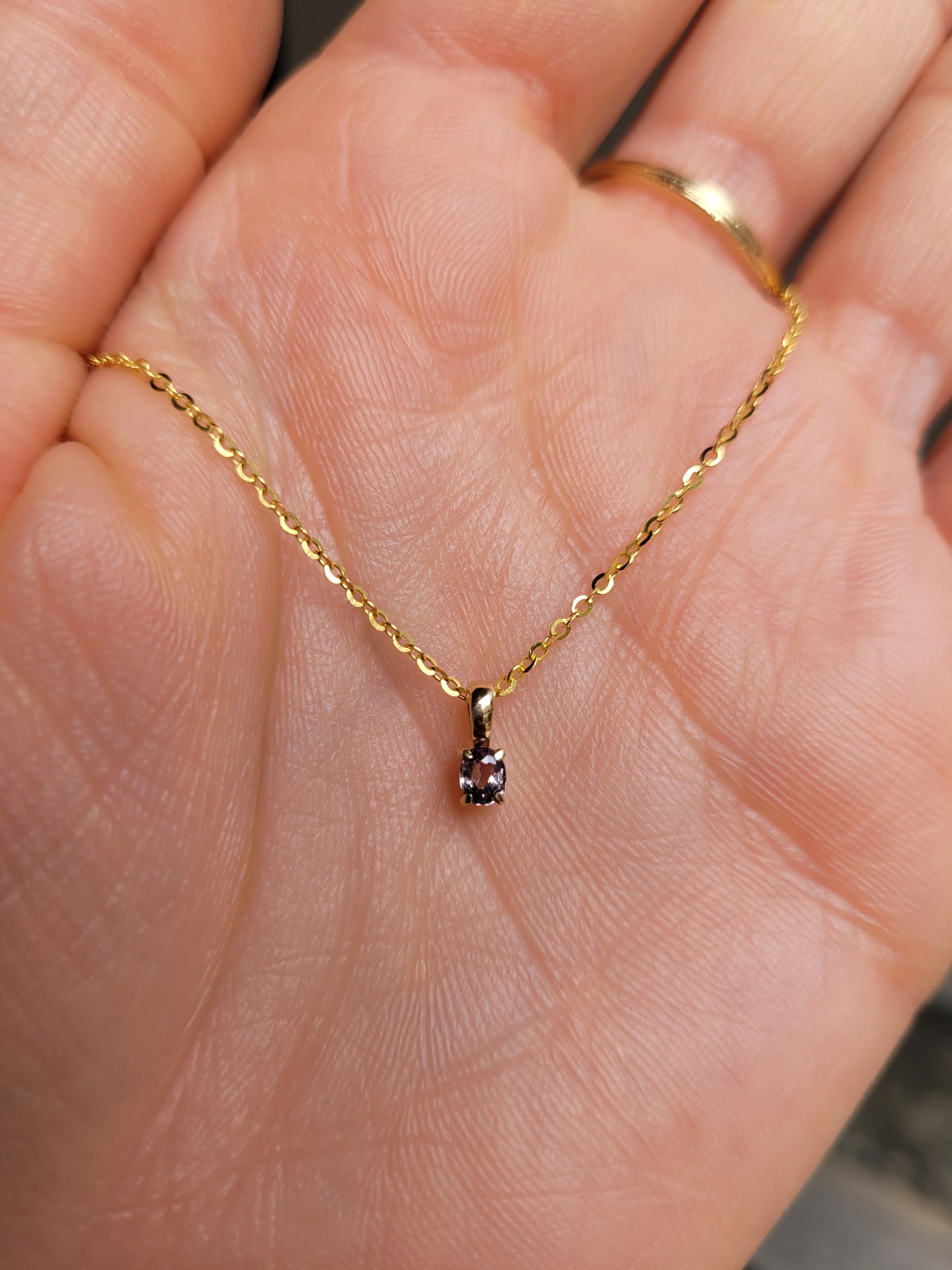 view on hand of Petite Oval Alexandrite Pendant in 18K Yellow Gold – 0.16ct 