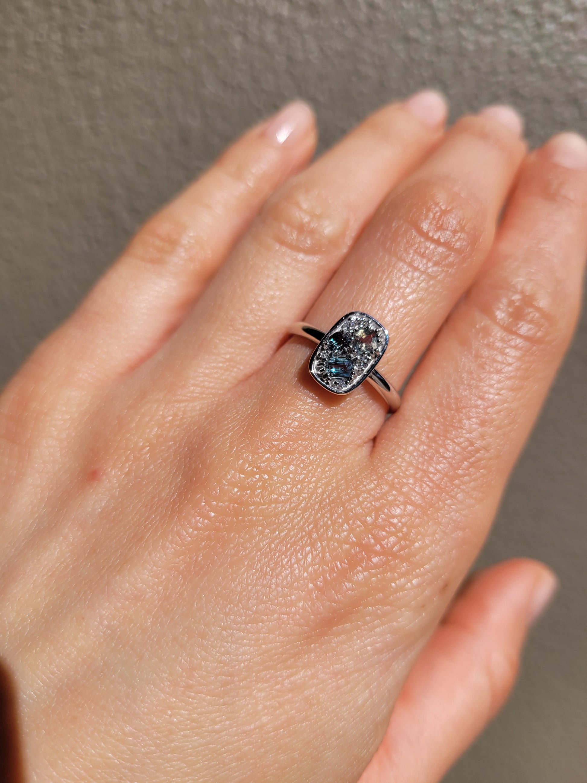 view of a hand wearing a Natural Alexandrite & Diamond Composition Ring in Platinum