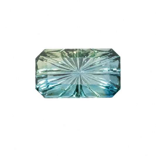 A single rectangular emerald-cut unheated teal sapphire with a fantasy cut or star pattern, showing a light blue-green color with subtle green undertones, isolated on a solid white background.