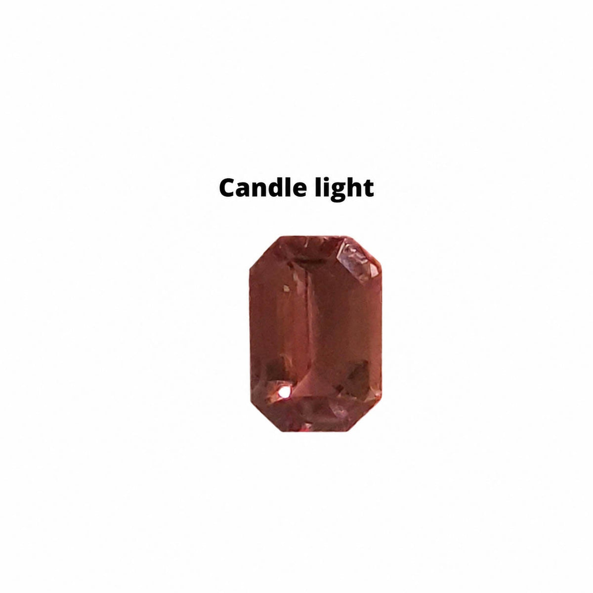 0.66 ct alexandrite under warm light showing its colour change
