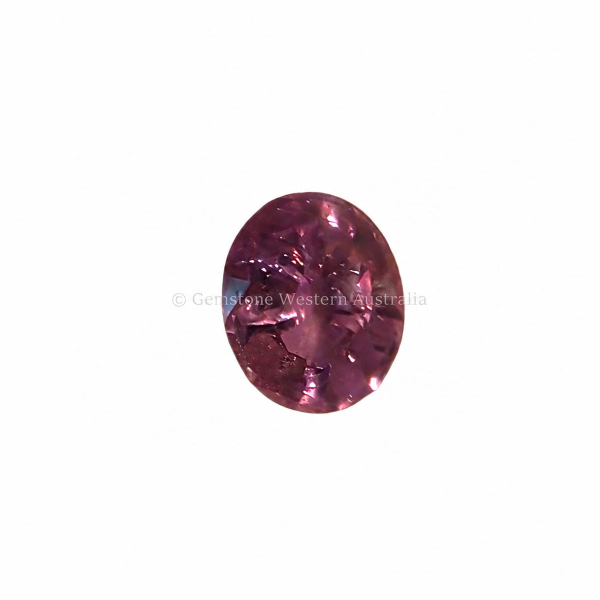 1.50 ct alexandrite under warm light showing its colour change