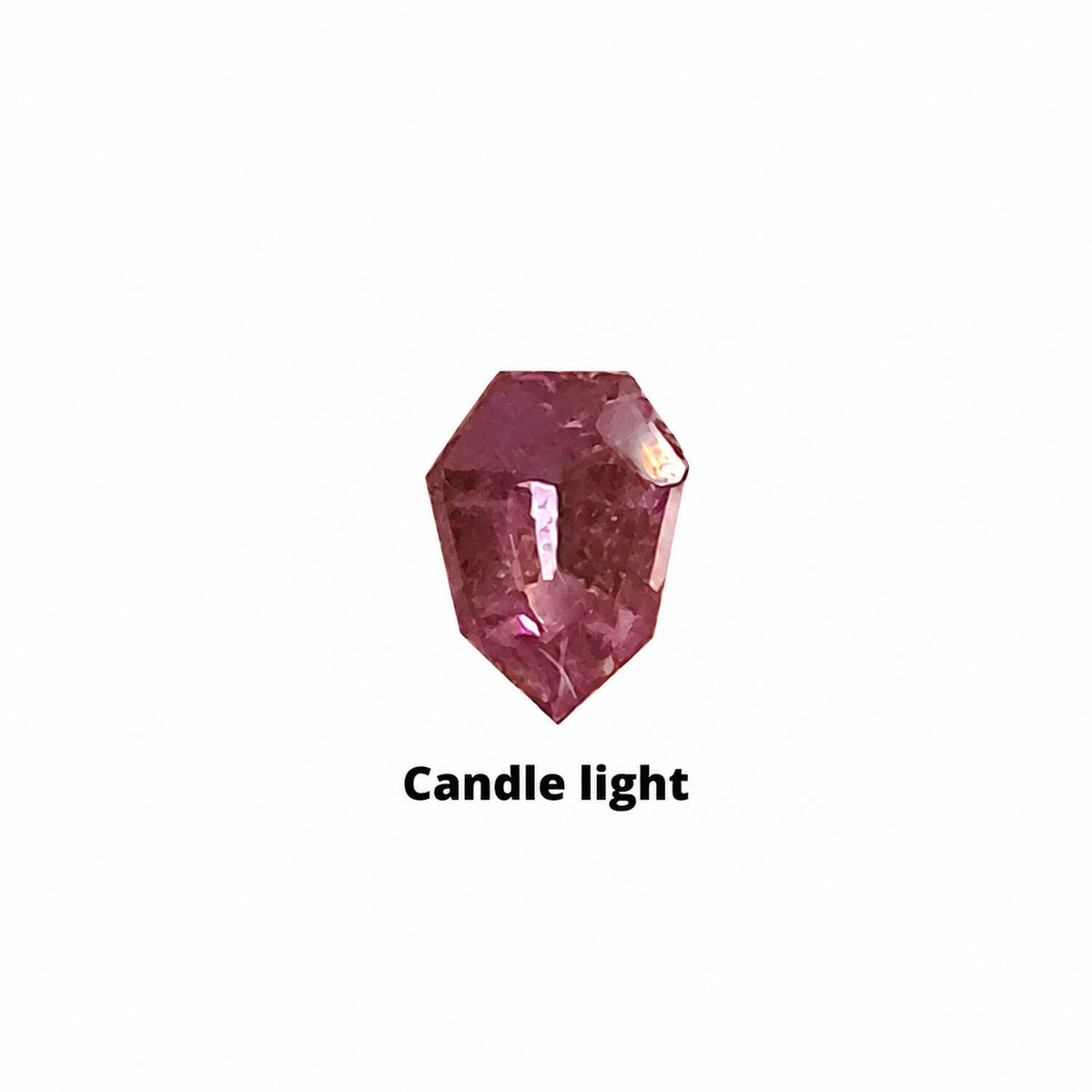 0.24 ct alexandrite under warm light showing its colour change