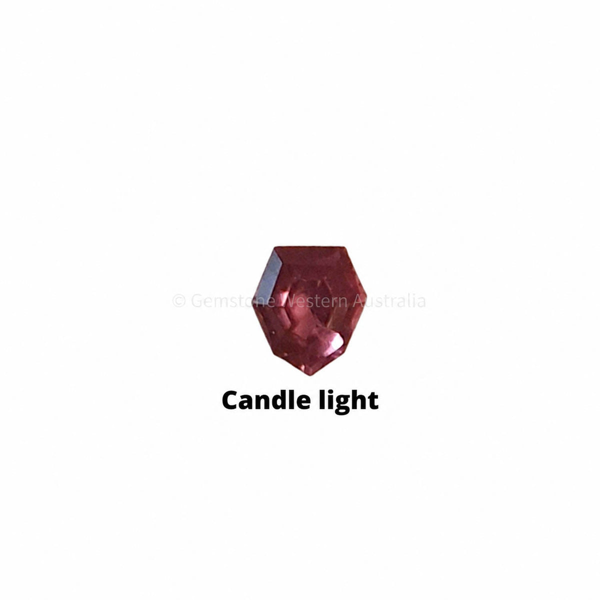 0.21 ct alexandrite under warm light showing its colour change