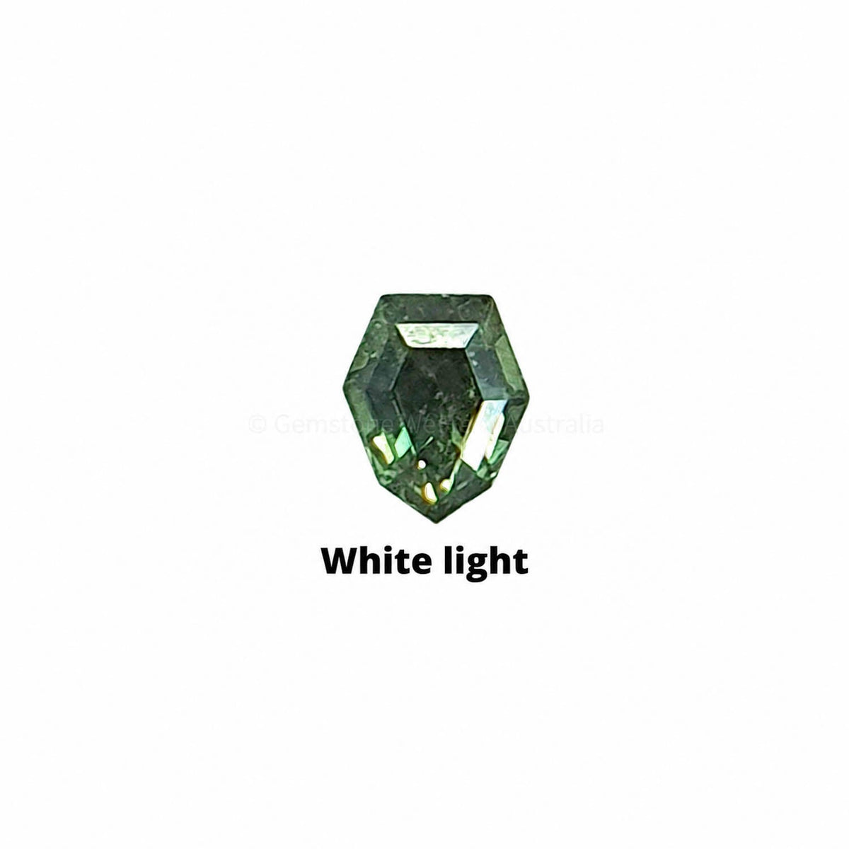 0.24 ct shield cut alexandrite photographed in daylight