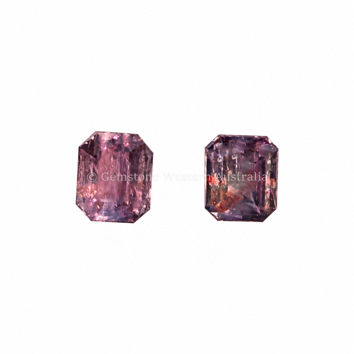 0.78 ct alexandrite pair under warm light showing their colour change