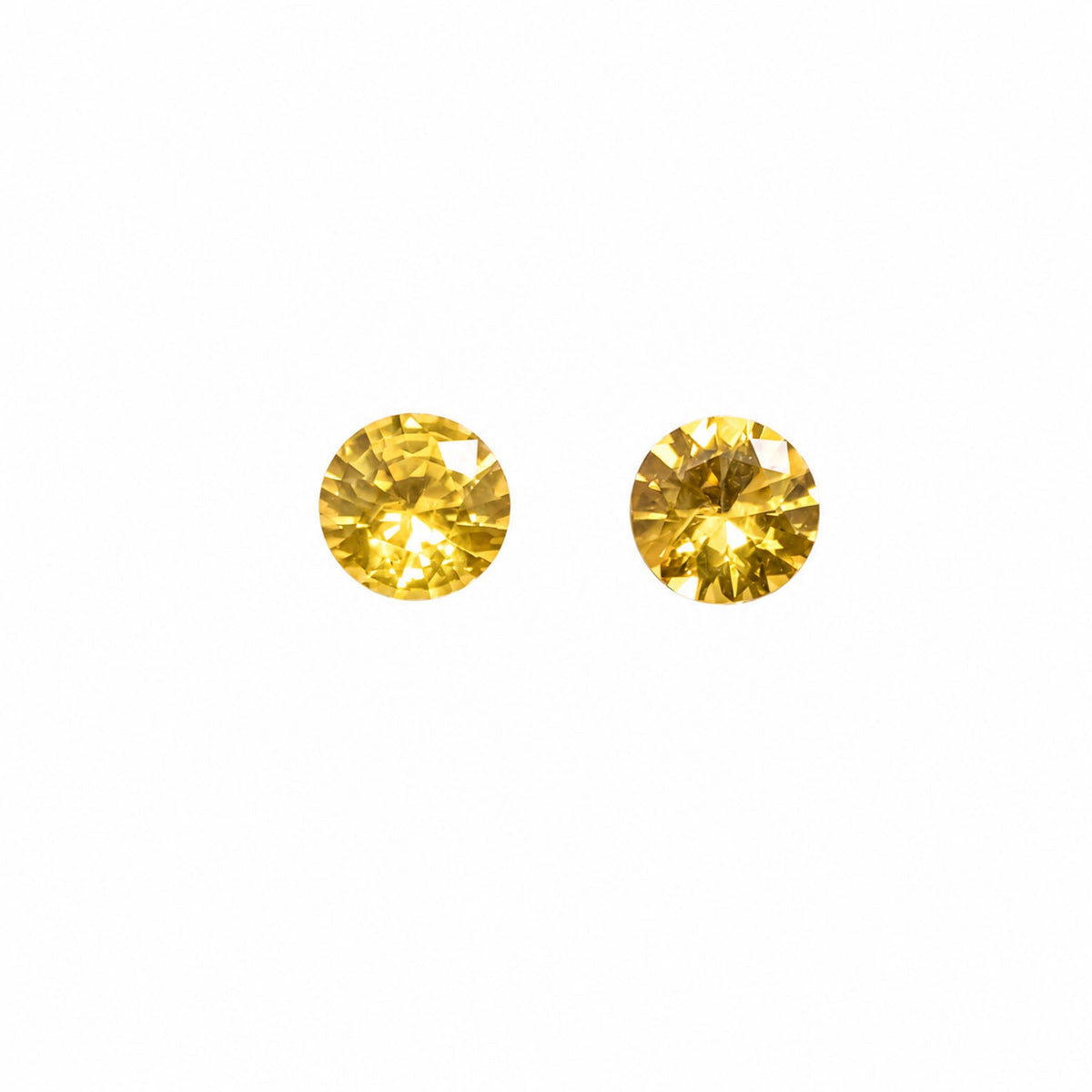 Matched pair of natural unheated yellow sapphires totalling 0.71 ct, round 4.4 mm