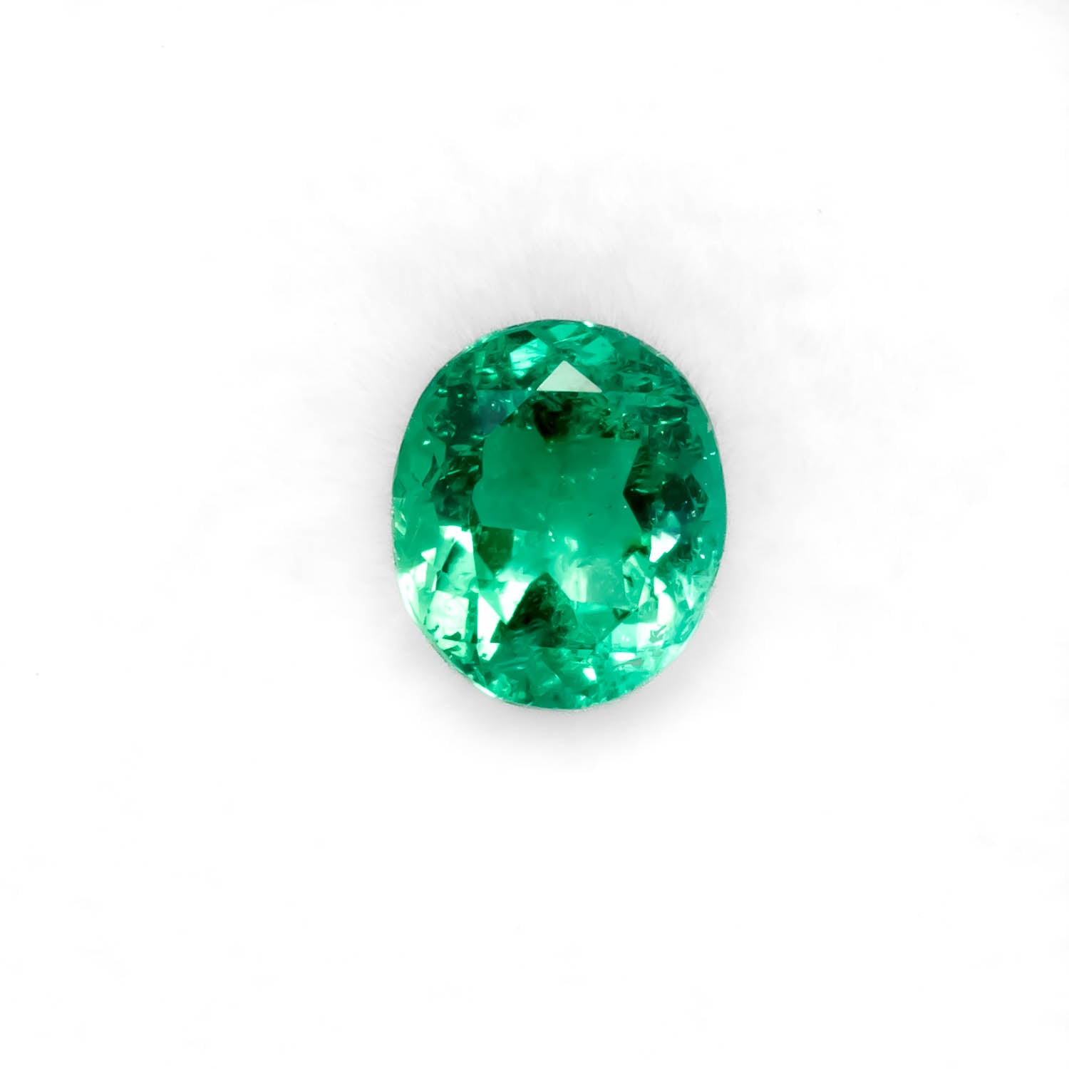 Front view of 1.04CT Natural Colombian Emerald – Round Cut Vivid Green Gemstonein white background.