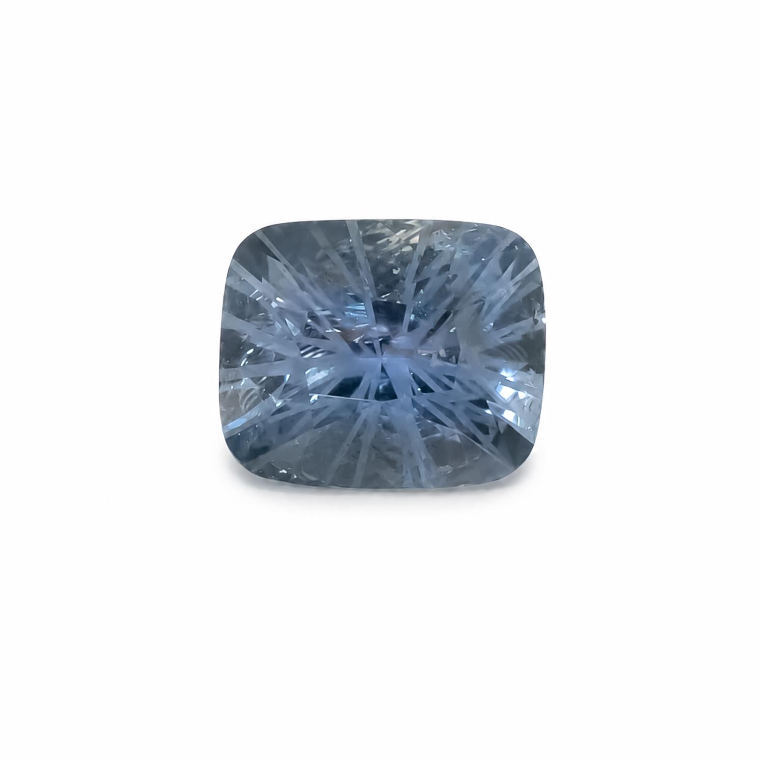 A cushion-cut blue teal sapphire gemstone with a brilliant starburst internal pattern, shown on a clean white background.