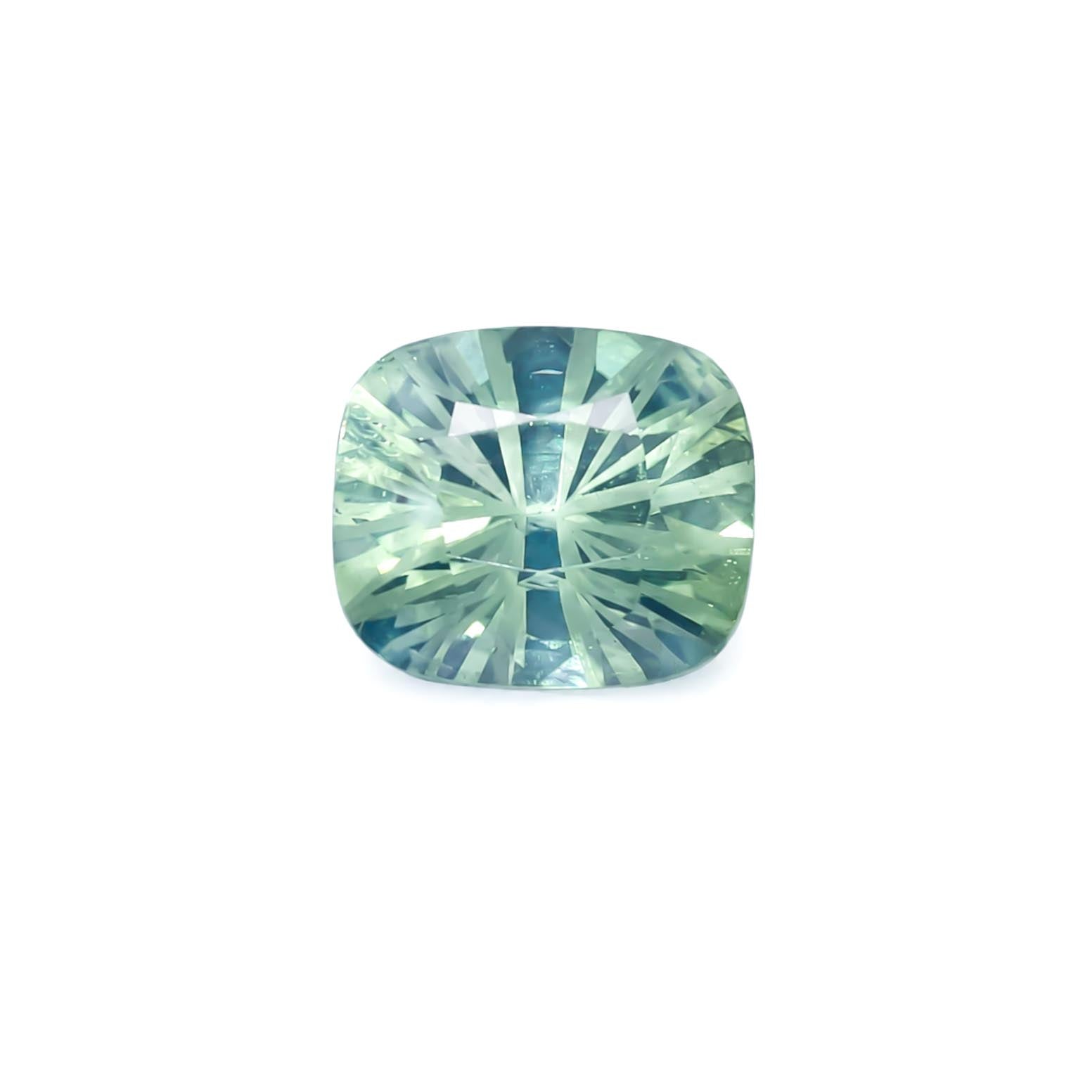 A cushion cut natural teal sapphire showing blue and green colours in a white background