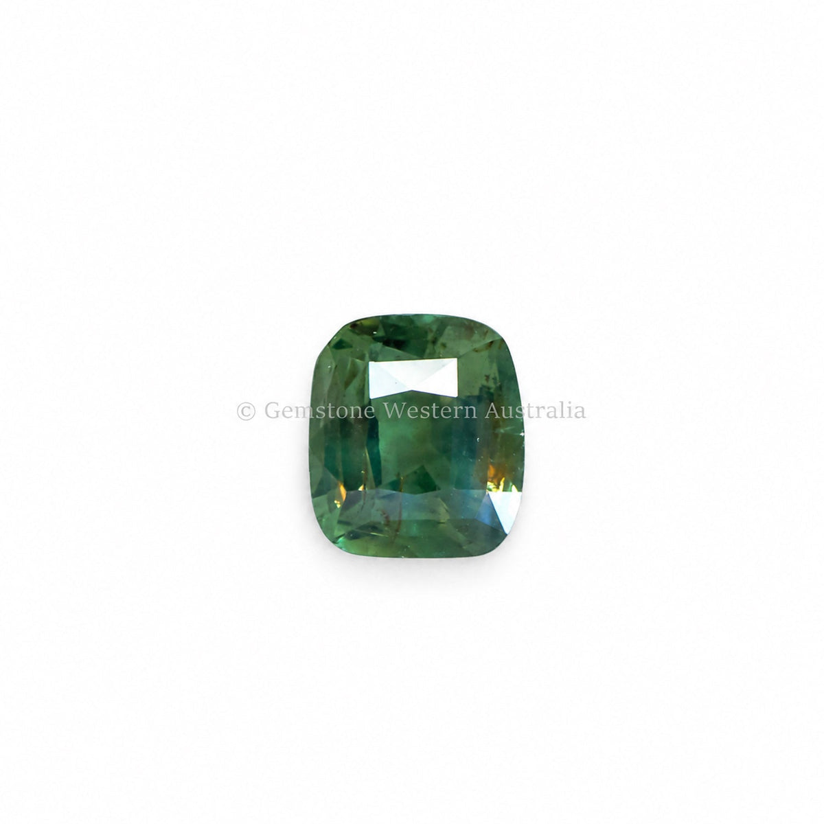1.05 ct alexandrite showing its colour change under warm light